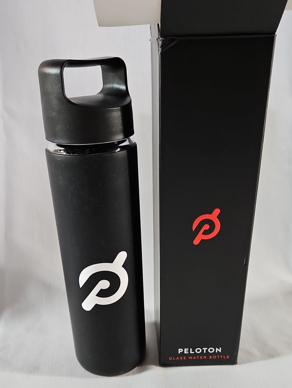 NIB, Peloton Premium Glass Water Bottle with Black Matte Silicone Sleeve, 16 oz